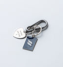 Silver metal keychain with polished finish, deep-blue tag engraved with Sleeves Studios icon, silver heart on back stamped “We love you, baby,” designed as a meaningful accessory