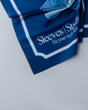 Blue scarf with white text on a light gray background - blue bandanna / headscarf  with text "tie your style baby" Sleeves Studios' branding