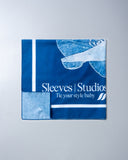 Blue fabric with 'Sleeves Studios' branding on a gray background - blue bandanna / headscarf  with text "tie your style baby" Sleeves Studios' branding