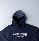 Washed navy oversized hoodie in premium heavyweight cotton, ultra-soft feel, with SLV logo and “Smile Baby” print on front, designed for comfort and vintage vibes by Sleeves Studios