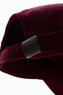 Red corduroy cap with soft ribbed texture, curved “Sleeves Studios” front embroidery, brand icon below, SLV initials on the side, structured crown and adjustable back for custom fit