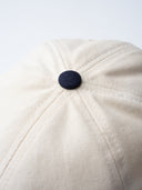 white and blue cotton cap, lightweight and breathable, SLV initials embroidered above the visor, Sleeves Studios icon on back, adjustable strap for one-size fit