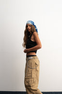 Khaki cotton baggy pants with high-waisted street fit, elastic back waistband, side and back pockets, zipper fly, and relaxed drape for everyday comfort by Sleeves Studios