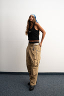 Khaki cotton baggy pants with high-waisted street fit, elastic back waistband, side and back pockets, zipper fly, and relaxed drape for everyday comfort by Sleeves Studios