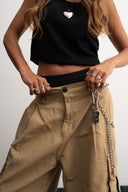 Khaki cotton baggy pants with high-waisted street fit, elastic back waistband, side and back pockets, zipper fly, and relaxed drape for everyday comfort by Sleeves Studios