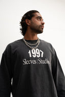 Washed grey 310gsm cotton long sleeve shirt, loose slightly cropped fit, bold “1997” graphic and Sleeves Studios logo on front, soft feel with structured drape