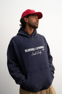Washed navy oversized hoodie in premium heavyweight cotton, ultra-soft feel, with SLV logo and “Smile Baby” print on front, designed for comfort and vintage vibes by Sleeves Studios
