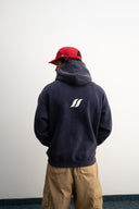 Washed navy oversized hoodie in premium heavyweight cotton, ultra-soft feel, with SLV logo and “Smile Baby” print on front, designed for comfort and vintage vibes by Sleeves Studios