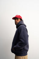 Washed navy oversized hoodie in premium heavyweight cotton, ultra-soft feel, with SLV logo and “Smile Baby” print on front, designed for comfort and vintage vibes by Sleeves Studios