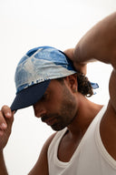 Man wearing a blue cap with denim pattern on a white background - blue bandanna / headscarf  with text "tie your style baby"background