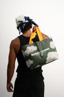 Cloud print laminated PP woven tote bag, 130gsm, with yellow-orange straps, Sleeves Studios logo and “Pack your style, baby!” slogan, lightweight and durable for daily use