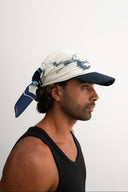  white and blue bandanna / headscarf with text "Wrap it with confidence baby"  and "Sleeves Studios" branding - Man wearing a black tank top and a white bandanna with  blue patterns on a plain background