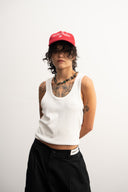 Red corduroy cap with soft ribbed texture, curved “Sleeves Studios” front embroidery, brand icon below, SLV initials on the side, structured crown and adjustable back for custom fit