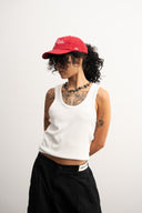 Red corduroy cap with soft ribbed texture, curved “Sleeves Studios” front embroidery, brand icon below, SLV initials on the side, structured crown and adjustable back for custom fit