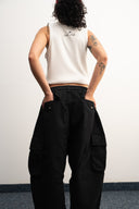 Khaki cotton baggy pants with high-waisted street fit, elastic back waistband, side and back pockets, zipper fly, and relaxed drape for everyday comfort by Sleeves Studios