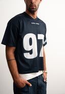 Navy mesh jersey with soft breathable texture, relaxed drapey fit, bold “97” front graphic with logo, white contrast details and double stripe on sleeve for sporty edge by Sleeves Studios