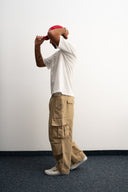 Khaki cotton baggy pants with high-waisted street fit, elastic back waistband, side and back pockets, zipper fly, and relaxed drape for everyday comfort by Sleeves Studios