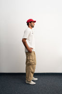 Khaki cotton baggy pants with high-waisted street fit, elastic back waistband, side and back pockets, zipper fly, and relaxed drape for everyday comfort by Sleeves Studios