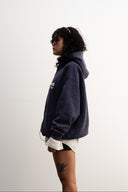 Washed navy oversized hoodie in premium heavyweight cotton, ultra-soft feel, with SLV logo and “Smile Baby” print on front, designed for comfort and vintage vibes by Sleeves Studios