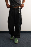 Khaki cotton baggy pants with high-waisted street fit, elastic back waistband, side and back pockets, zipper fly, and relaxed drape for everyday comfort by Sleeves Studios