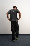 Khaki cotton baggy pants with high-waisted street fit, elastic back waistband, side and back pockets, zipper fly, and relaxed drape for everyday comfort by Sleeves Studios