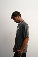 Washed grey oversized 100% heavyweight cotton t-shirt, soft and breathable with relaxed drape, brand logo and “Dream Big Baby” print, ESTD 2023 details by Sleeves Studios