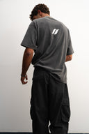 Washed grey oversized 100% heavyweight cotton t-shirt, soft and breathable with relaxed drape, brand logo and “Dream Big Baby” print, ESTD 2023 details by Sleeves Studios