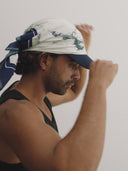  white and blue bandanna / headscarf with text "Wrap it with confidence baby"  and "Sleeves Studios" branding