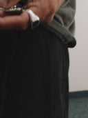 Keychain with heart-shaped tag and square keyring on a gray background